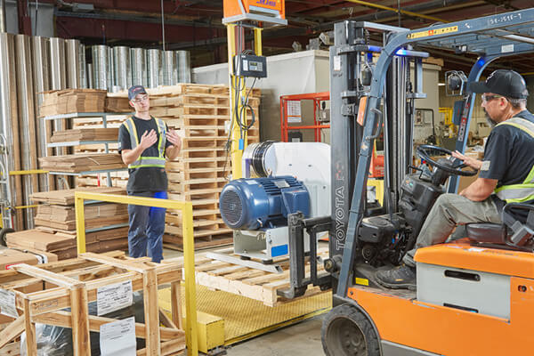 Worker using forklift for shipping